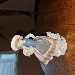 Lladro women holding basket of flowers